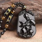 Accessoire religieux : collier obsidien Bouddha Avalokiteśvara